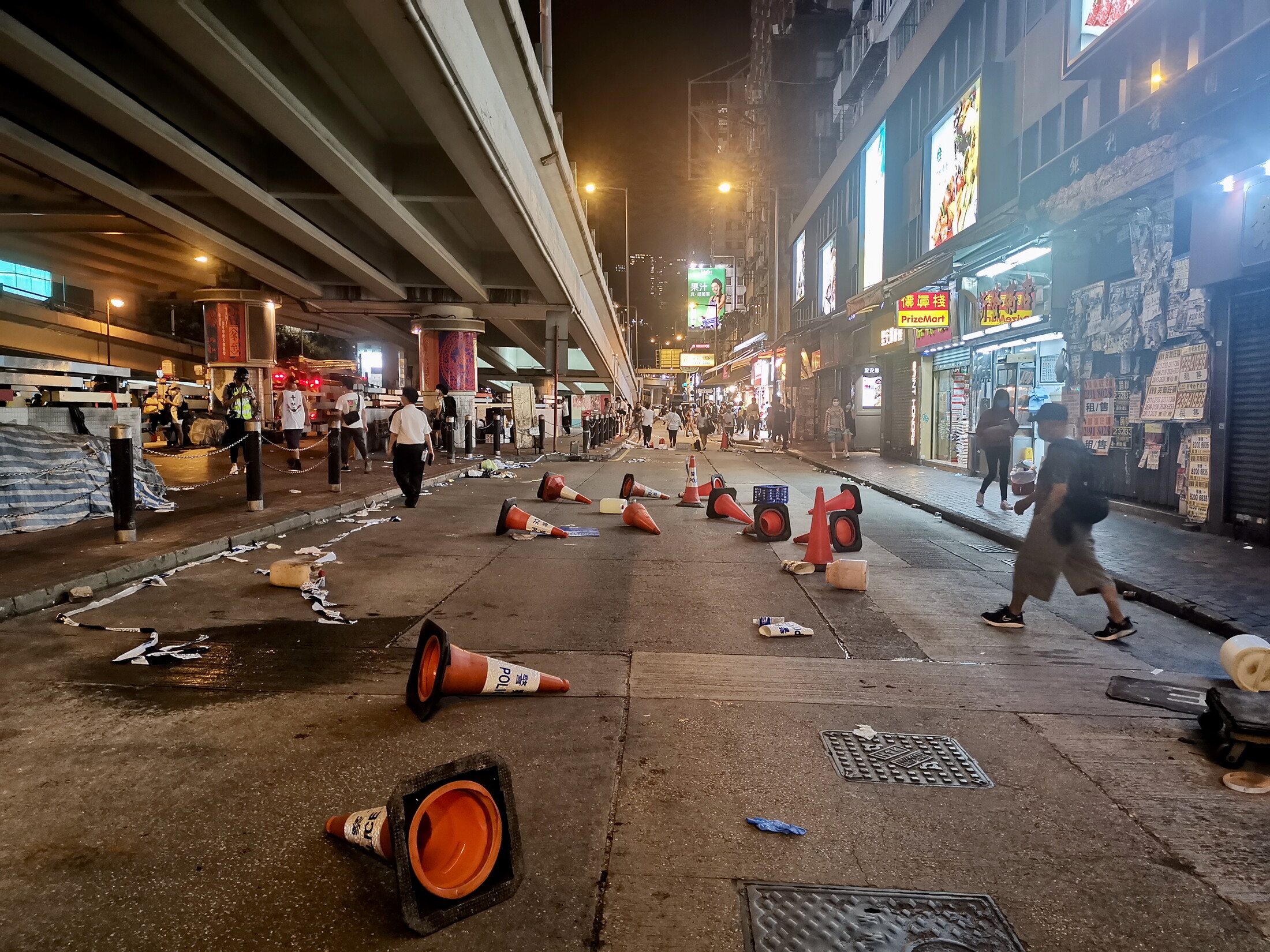 The aftermath of a Hong Kong protest, with police cones laying on a street near Causeway Bay