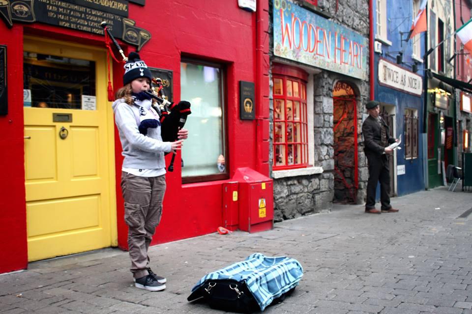 Girl playing bagpipes in Galway