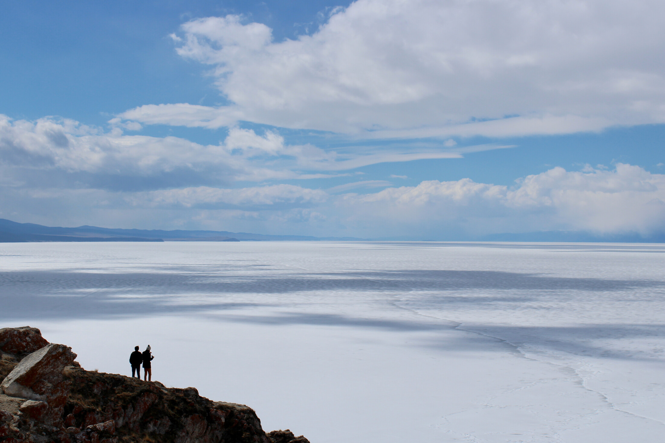 Two people looking from one of the northern cliffs on Olkhon Island