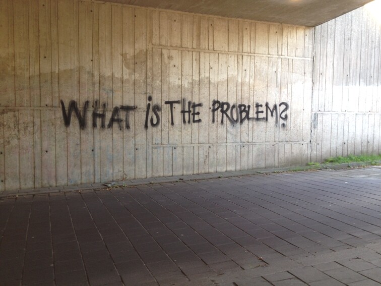 Graffiti in Amsterdam asking "what is the problem?" by laser
