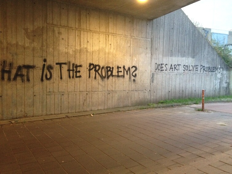 More graffiti next to it asking "Does art solve problems?"